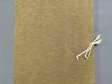 a close up of a piece of cloth with a string tied to it