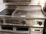 a stove with two ovens and a microwave in the kitchen