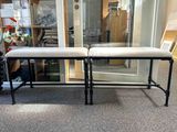 two benches that are sitting in front of a glass door