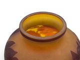 a vase with a yellow and brown design on it
