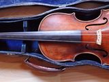 a violin that is sitting in a case on the floor