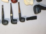 a lot of different types of smoking pipes on the table