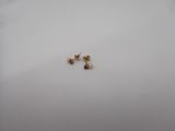 a close up of a pair of earrings sitting on top of a white surface