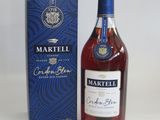 a bottle of martelli cognale with a box on a table