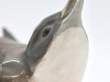 a figurine of a bird that is sitting on a table