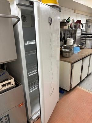 an image of a kitchen with a refrigerator and other appliances