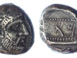 a silver coin with an image of a man on it