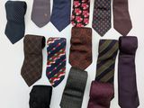 many ties laid out on a white surface