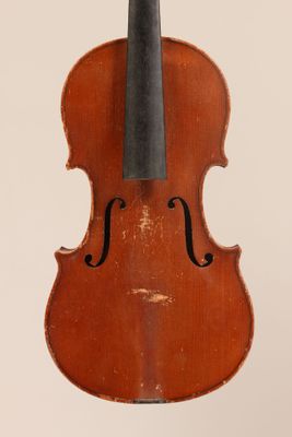 un vieux violon posé sur une surface blanche