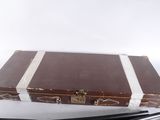 a suitcase and a pair of scissors on a table