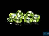 a group of green gems on a black surface