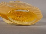 a yellow glass object that is sitting on a table
