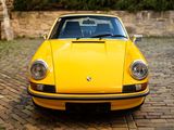 a yellow car parked on a cobblestone street