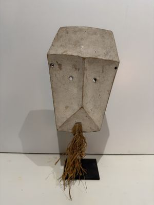 a sculpture of a face made out of cement