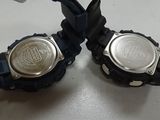 two watches that are sitting on a table