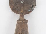 an image of a wooden sculpture of a woman with a flower in her hair