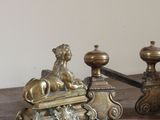 two antique brass candlesticks on a wooden table