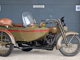 a motorcycle with a side car parked in front of a garage