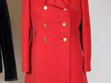 two coats on a mannequin stand with fur collars