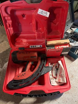 a red tool case with tools in it on the floor