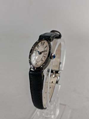 an image of a close up of a wrist watch on a clear surface