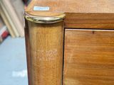 a close up of a wooden desk with a metal handle