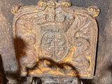 an old cast iron fire place with a coat of arms on it
