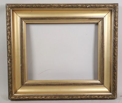a gold picture frame on a white wall with a white background