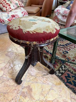 a small stool with a red seat in a living room