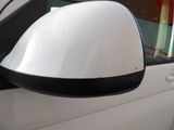 a side view mirror of a white car with a black trim