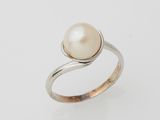 a white pearl and silver ring on a white background