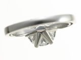 a close up of a ring with a diamond in it