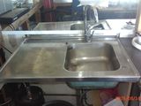 a sink in the middle of a kitchen with a lot of counter space