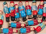 many figurines in a box that are in the shape of people