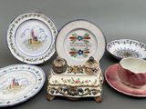 many different plates and cups on the table
