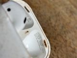 two airpods that are sitting on a wooden floor