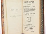 an open book with a picture of a wreath on the cover