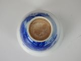 a blue and white bowl with a coffee inside of it