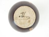 a close up of a brown vase with a number on it