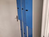 two blue lockers in the corner of a room