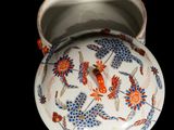 an image of a bowl with a lid on a black background