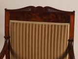 a wooden chair with a striped upholstered seat
