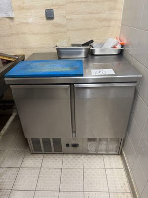 a small kitchen with a blue counter top in the corner of the room