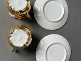 three cups and saucers sitting on a table