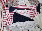 a lot of shirts that are laying on the floor