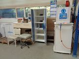 an image of a room with a refrigerator, desk, and a chair