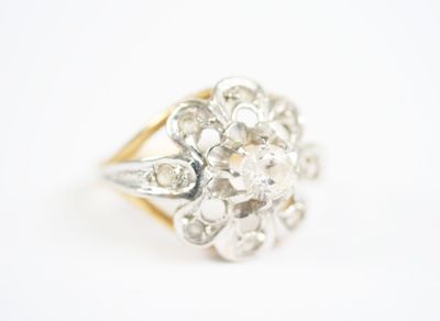 a close up of a diamond ring on a white surface