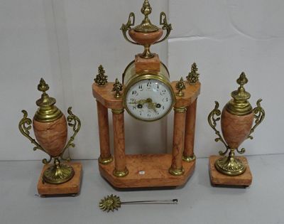 a clock that is sitting on a table next to three vases