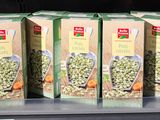three boxes of food are on a shelf in a store
