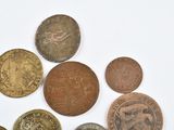 a lot of coins that are on a white surface